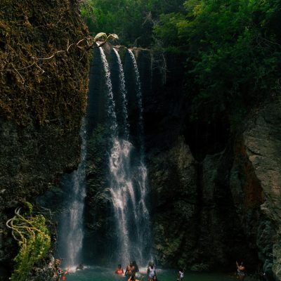 people standing near waterfalls during daytime