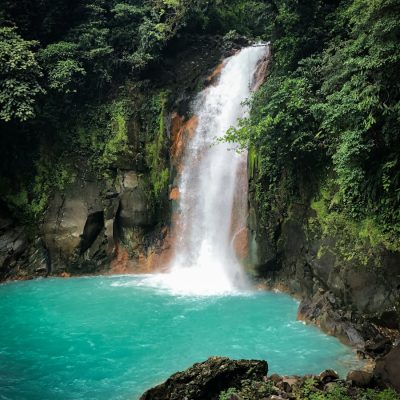 waterfalls in the middle of the forest during daytime